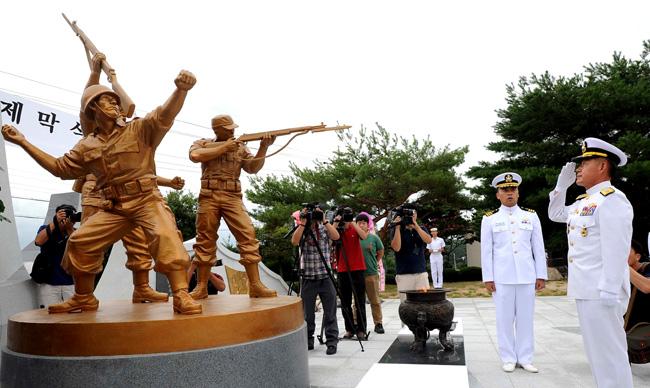 최윤희 해군참모총장이 3일 열린 해군육전대전적비 제막식에서 헌화·분향한 후 거수경례를 하고 있다.