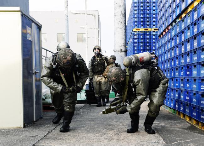 공군18전비 화생방 신속대응팀 장병들이 화학물질이 보관된 창고에 진입해 오염 여부를 탐지하고 있다.  사진 제공=고태호 상사
