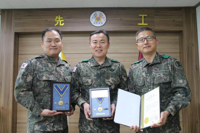 육군2공병여단 박민규 대위, 김혁년 중령, 최동식 상사(왼쪽부터)가 헌혈 100회를 달성해 헌혈 유공장 명예장을 들고 사진을 찍고 있다.  부대 제공