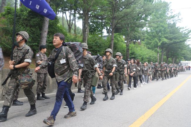 육군75사단이 진행한 무박 2일 100㎞ 장거리 지속행군에서 동반 행군하는 장병과 그 가족들이 부대로 들어오고 있다.  부대 제공