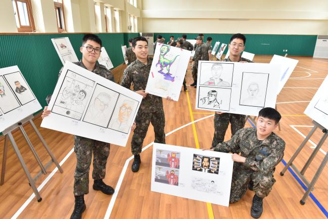 공군방공관제사령부 예하 8546부대가 17일부터 오는 19일까지 부대 체육관에서 열고 있는 미술동아리 작품전시회에서 장병들이 자신의 그림을 들어 보이고 있다.  부대 제공