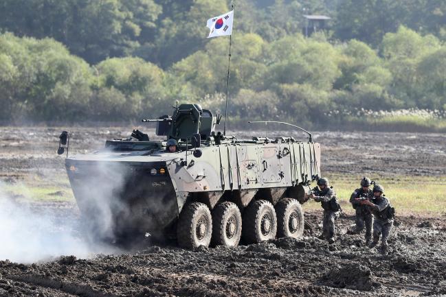 지난 4일 충남 계룡대에서 열린 지상군 페스티벌 행사에서 무인로봇, 드론 등 육군의 새로운 전투체계를 활용한 미래 전투상황 시연 중 장병들이 K808 차륜형 장갑차와 함께 기동하고 있다. 한재호 기자