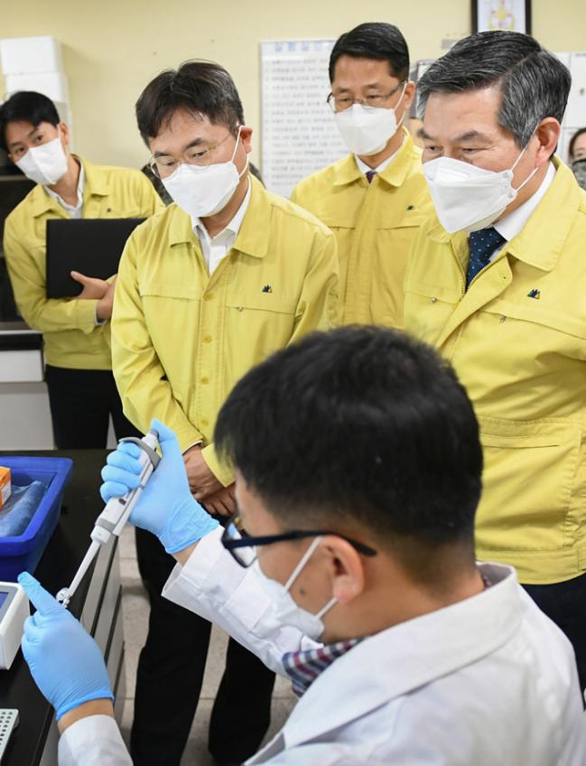 정경두(둘째줄 오른쪽) 국방부 장관이 25일 대전시 유성구 소재 국군의학연구소를 방문해 감염병 신속 진단법 시연을 보고 있다.  
 국방부 제공