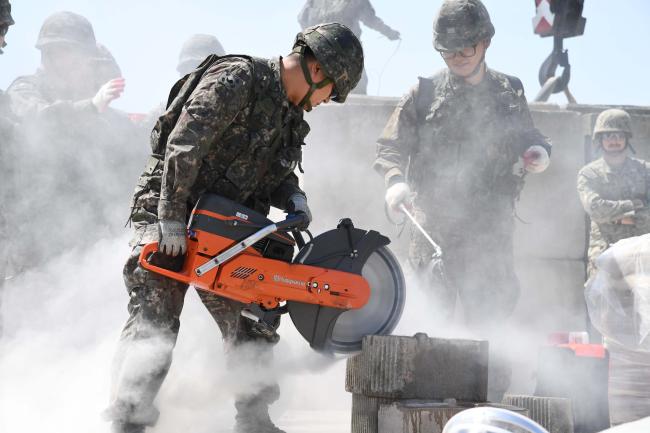 지난 2018년 미군과 실시한 항만피해복구훈련에서 59기동건설전대 1기동건설대대 장병들이 콘크리트를 절단하고 있다.  
 