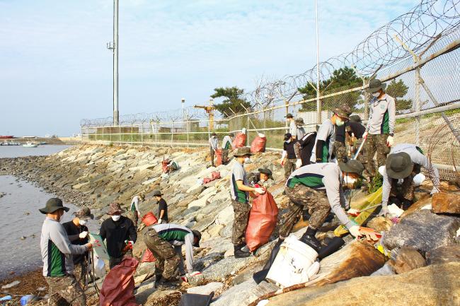 육군51사단 장병들이 경기도 화성시 궁평해수욕장에서 해안으로 밀려온 쓰레기를 수거하고 있다. 
 부대 제공