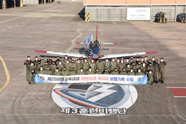 공군3훈련비행단 215비행교육대대 대대원들이 ‘20만 시간 무사고 비행기록’을 수립을 축하하며 KT-1 항공기 앞에서 기념사진을 촬영하고 있다. 부대 제공