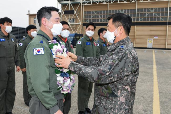 전인석 5공중기동비행단장이 11일 창대일과 비행기록 무사고 33주년 달성을 축하하며 양진우 소령에게 꽃다발을 증정하고 있다. 사진 제공=노현우 하사