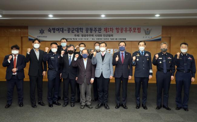 18일 서울 용산구 숙명여자대학교 백주년기념관에서 공군대학과 숙명여대가 ‘항공우주력 시대와 민·군 협력’을 주제로 공동 개최한 제1차 항공우주포럼에 앞서 참석자들이 기념사진을 찍고 있다.  한재호 기자