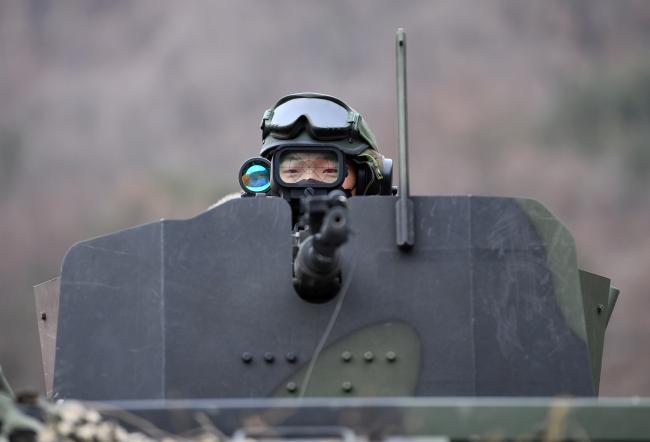 차륜형장갑차의 건쉴드 사이로 K6 기관총 사격을 준비하는 쌍용여단 전투단 장병의 모습.