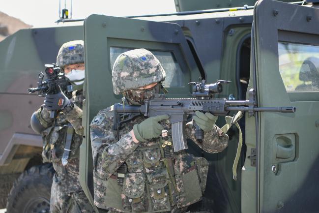 공군20전투비행단 2021-1차 전투태세훈련(ORE)에서 KF-16 전투기가 유사시 신속한 항공작전 수행을 위한 ‘긴급 발진’ 훈련을 위해 활주로에서 이동하고 있다. 오른쪽 사진은 대테러 요원들이 테러범에게 총을 겨누고 있는 모습. 사진 제공=서복남 원사/이재민 중사 