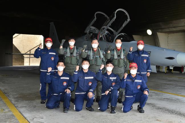 원인철(뒷줄 가운데) 합참의장이 13일 F-5 전투기 지휘비행에 앞서 공군10전투비행단 장병들을 격려한 뒤 기념 촬영을 하고 있다.  합참 제공