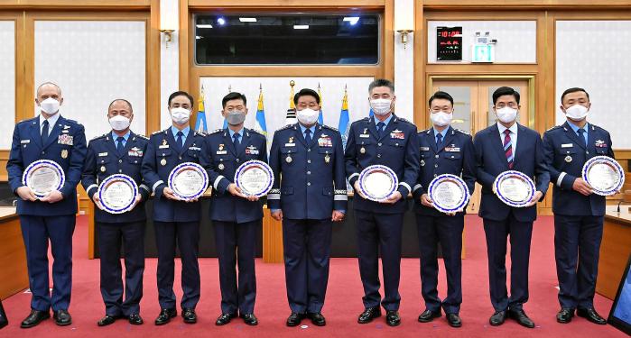 지난 24일 공군본부에서 열린 ‘2021년 공군을 빛낸 인물’ 시상식에서 박인호(가운데) 참모총장과 각 부문 수상자들이 기념사진을 찍고 있다. 왼쪽부터 미7공군 에이브러햄슨 중령, 5공중기동비행단 정연학 대령, 항공자원관리단 문우범 대령, 항공우주작전본부 황영식 대령, 박 총장, 항공우주전투발전단 정한진 대령, 정보화기획참모부 강태우 대령, 강창부 공군박물관장, 공군방역대책본부 박정훈 중령.  공군 제공 