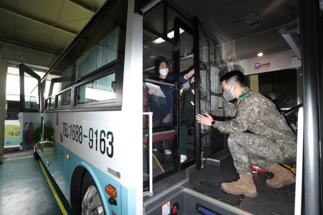 26일 국군의무사령부 예하 국군양주병원 감염관리실 및 의무후송중대 관계자들이 감염관리지침에 따라 군단지원병원 버스에 설치된 격벽의 이상 유무를 확인하고 있다.  이경원 기자