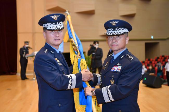정상화(왼쪽) 공군참모총장이 14일 이상학(중장) 신임 공군사관학교장에게 부대기를 이양하고 있다. 사진 제공=김경률 원사