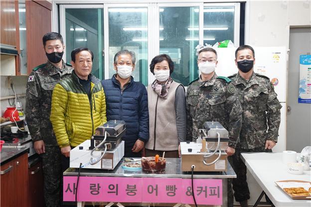 육군종합군수학교 2수송연대 장병들이 경북 경산시 남천면 경로당에서 붕어빵을 직접 만들어 드리는 활동에 앞서 주민들과 포즈를 취하고 있다. 부대 제공