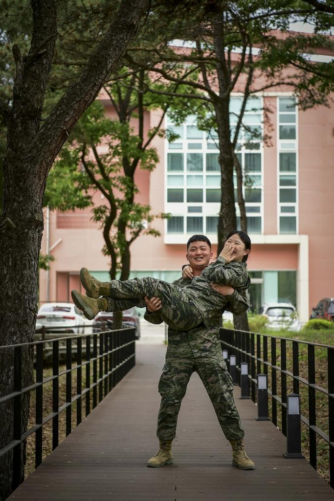 해병대2사단 김남강 중위가 아내 장유연 중위를 번쩍 안아들고 기념사진을 찍고 있다. 사진 제공=권규원 중사