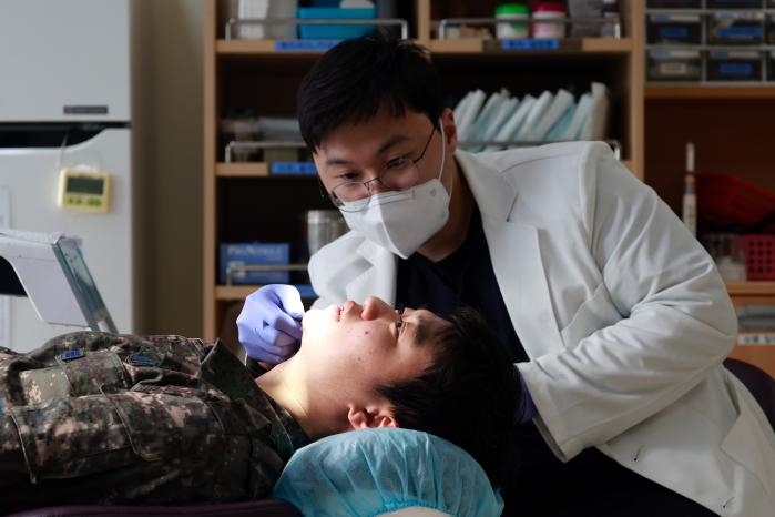 공군8전투비행단 수면클리닉을 찾은 한 장병이 수면장애 원인을 찾기 위해 치과 군의관 김태현 대위에게 진료받고 있다.