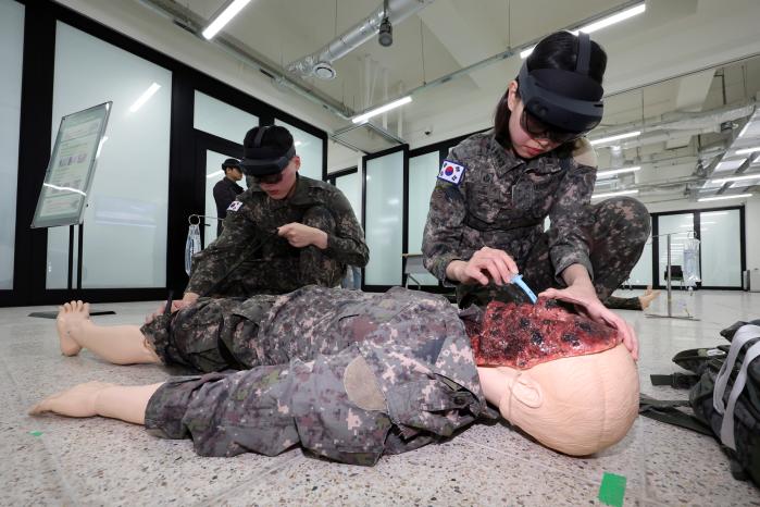 의무종합훈련센터에서 진행된 증강현실(AR) 기술 기반 교육·훈련체계 시연 행사 중 국군의무학교 교관·조교가 AR 활용 환자처치 과업 교육을 선보이고 있다.