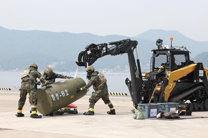 22일 해군군수사령부 병기탄약창에서 진행된 ‘2024년 연합·합동 폭발물처리 세미나 및 훈련’ 2일 차 훈련에서 공군 장병들이 ‘활주로 불발탄 원격처리장비’로 인양한 적 전술탄도탄을 확인하고 있다. 양동욱 기자