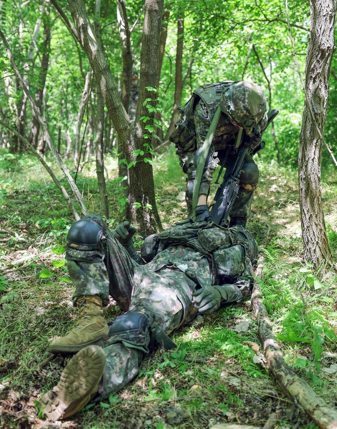 육군15보병사단 을지여단 장병이 지난 4일 열린 소대 전술 훈련 중 총상을 입은 전우를 안전지대로 옮기고 있다.