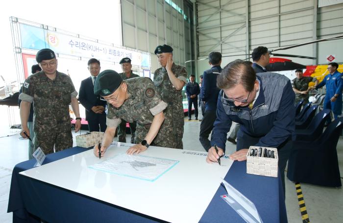 강구영(맨 오른쪽) KAI 사장과 박중동(준장·오른쪽 둘째) 육군항공사령부 부사령관이 수리온 최종호기 납품 기념식에서 서명을 하고 있다. KAI 제공