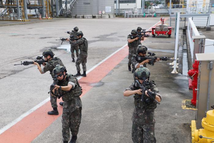 육군31보병사단 횃불여단 장병과 영암군 예비군 기동대원들이 지난 22일 전남 영암군 GS칼텍스 목포물류센터에서 열린 통합방위훈련 중 거수자를 제압하기 위해 수색작전을 펼치고 있다. 부대 제공