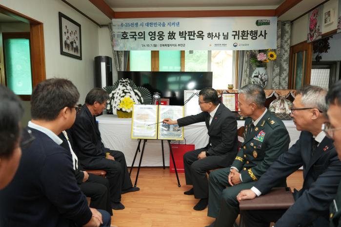 이근원(오른쪽 셋째) 국유단장이 7일 전북 부안군에 있는 고(故) 박판옥 하사 유가족 자택에서 ‘호국의 영웅 귀환 행사’를 열고, 유가족에게 고인의 참전 과정과 유해 발굴 경과를 설명하고 있다. 국방부 제공