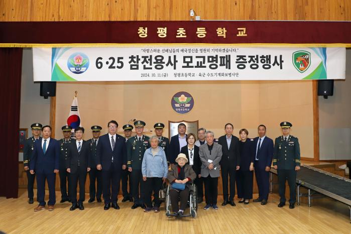 육군수도기계화보병사단이 지난 11일 청평초등학교에서 개최한 6·25전쟁 참전용사 모교 명패 증정 행사에서 참석자들이 기념사진을 찍고 있다. 부대 제공