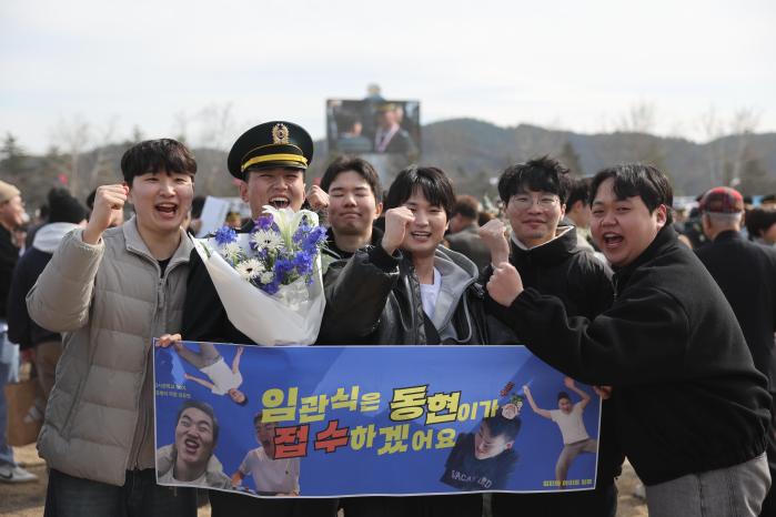 신임 소위가 졸업 및 임관식에 참석한 친구들과 기쁨을 나누고 있다.