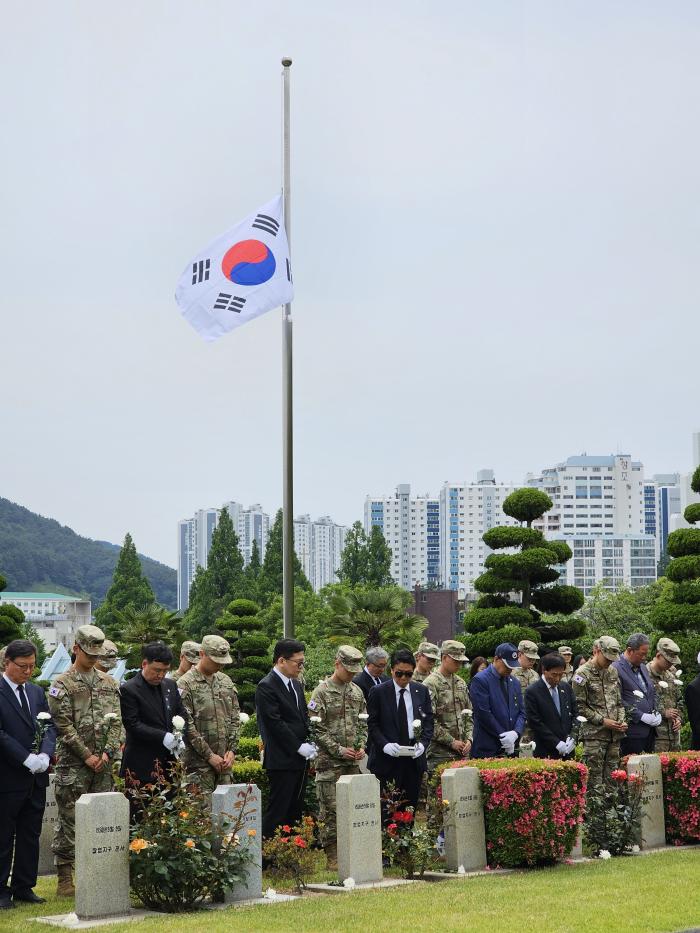 현충일인 지난 6일 부산시 유엔기념공원 카투사 묘역에서 현역 장병과 카투사연합회 회원들이 선배 카투사의 숭고한 희생을 기리며 묵념하고 있다. 주한 미8군 한국군지원단 제공