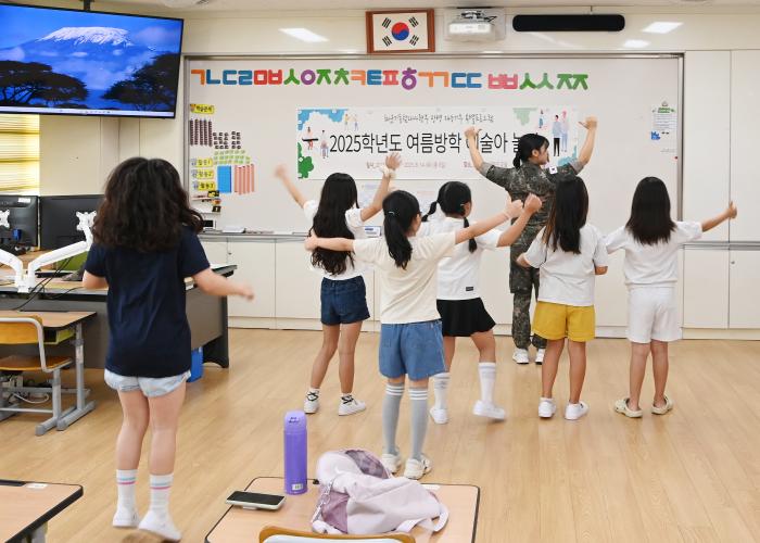 해군기동함대 홍선희 하사가 제주 강정초등학교 학생들에게 댄스 수업을 하며 춤 동작을 알려주고 있다. 사진 제공=김병훈 상사