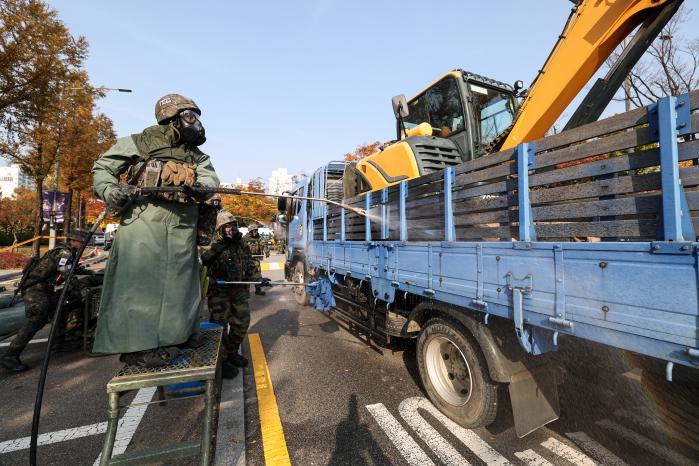 화생방지원대 장병들이 차량을 제독하는 모습.