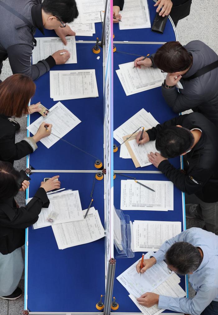 ‘2025 부산 잡(JOB) 페스티벌’이 열린 지난달 27일 부산시 해운대구 벡스코 제1전시장에서 구직자들이 참가신청서를 작성하고 있다. 연합뉴스