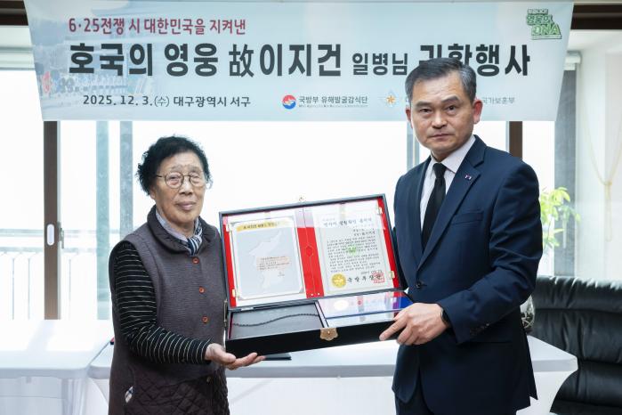 3일 열린 ‘호국의 영웅 귀환’ 행사에서 김종술(오른쪽) 대구지방보훈청장이 고 이지건 일병의 첫째 딸 이호분 여사에게 호국의 얼 함을 전달하고 있다. 부대 제공