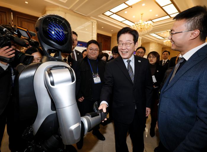 이재명 대통령이 7일 중국 상하이 국제회의중심에서 열린 한·중 벤처스타트업 서밋에서 중국 업체가 만든 휴머노이드 로봇과 악수하고 있다. 연합뉴스