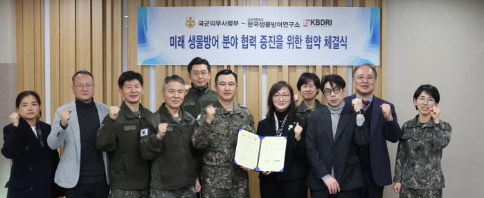국군의무사령부와 한국생물방어연구소 관계자들이 협약서를 들어 보이고 있다. 사진 제공=정원영 군무주무관