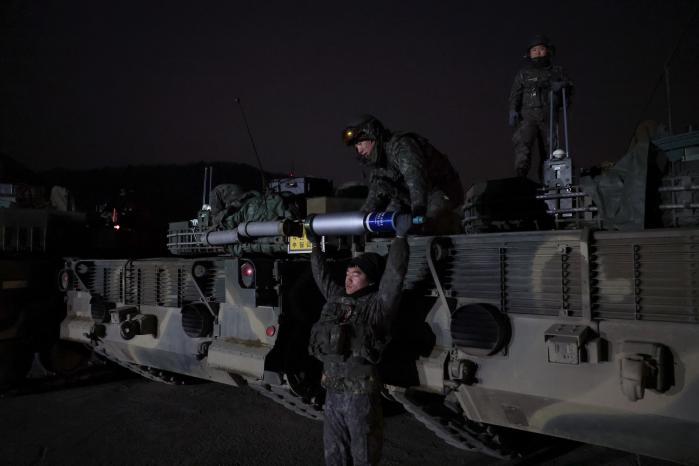 전차 승무원들이 120㎜ 전차포탄을 전달하고 있다.