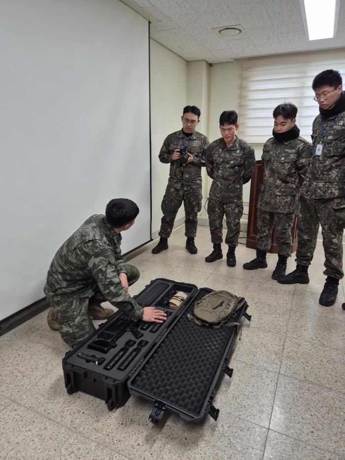 해군1함대 포항항만방어대대 장병들이 지난 13일 열린 합동 기지방호훈련에서 해병대 특수수색여단 장병에게 안티드론건 사용법을 교육받고 있다. 부대 제공