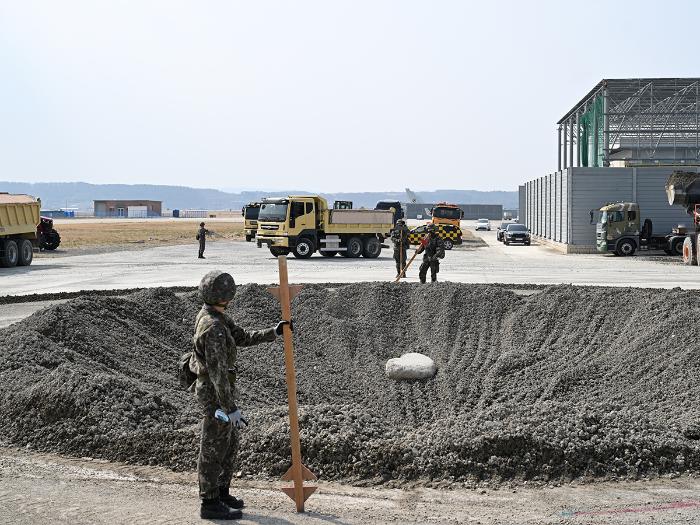 해군항공사령부 공병대대 장병들이 17일 활주로 피해복구 훈련을 전개해 대형 폭파구에 골재를 포설하고 있다. 사진 제공=문준원 하사