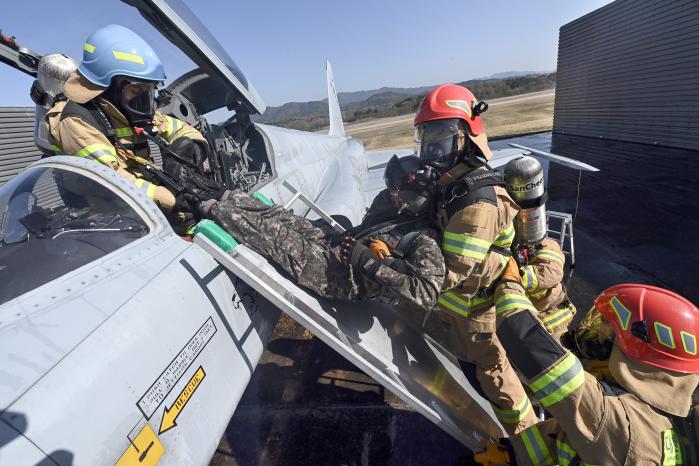 공군16전투비행단 소방구조중대 장병들이 소방구조훈련 중 항공기에서 조종사를 구조하고 있다. 사진 제공=이태희 상사
