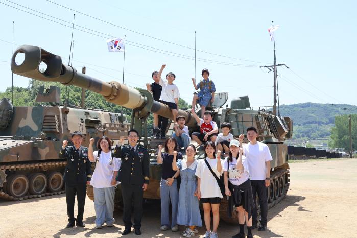 육군30기갑여단 하나포병대대가 개최한 부대개방행사에서 장병과 군인가족들이 K55A1 자주포 앞에서 기념사진을 찍고 있다.