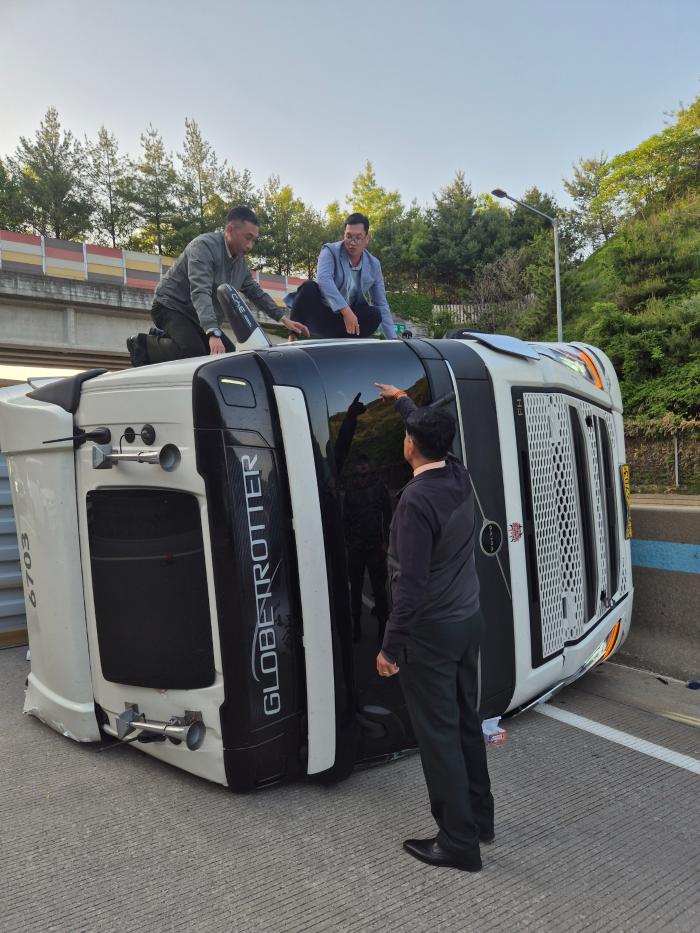 지난 15일 천안논산고속도로에서 전복된 덤프트럭 운전자를 구하기 위해 사고 차량에 올라간 시사왓(왼쪽) 대령과 브엉탄콩 대위. 부대 제공