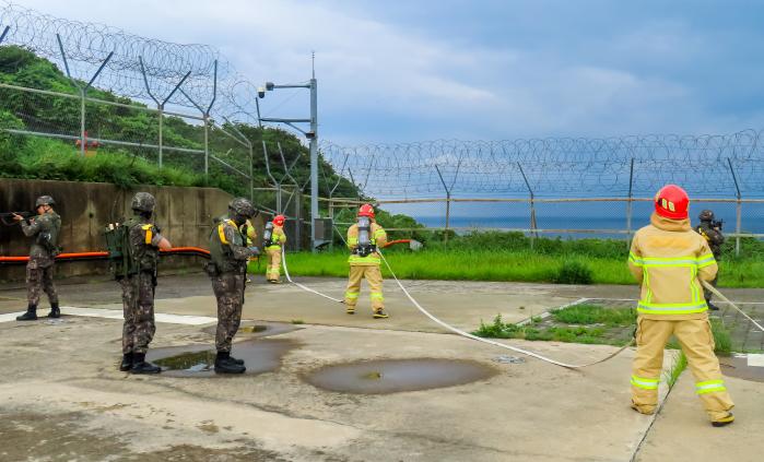 해군3함대 267해상감시장비운용대 장병들이 민·관·군 통합방위훈련 중 소방대원들과 함께 화재를 진압하고 있다. 부대 제공