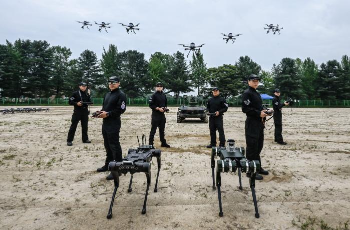 지난 28일 육군정보학교에서 개최된 육군 ‘드론·로봇 전술시범단 창설식’에서 전술시범단 장병들이 드론, 다족형 로봇, 다목적 무인차량 등 주요 장비 앞에서 포즈를 취하고 있다. 육군 제공